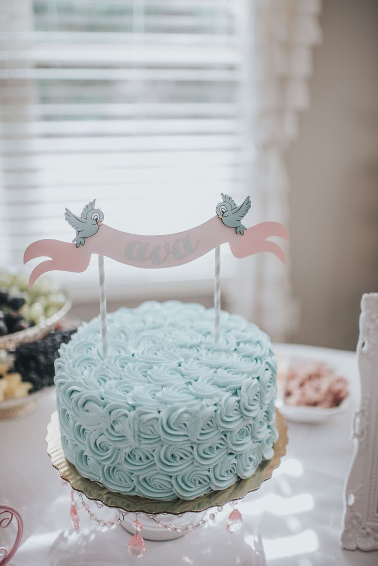 a blue cake sitting on top of a table