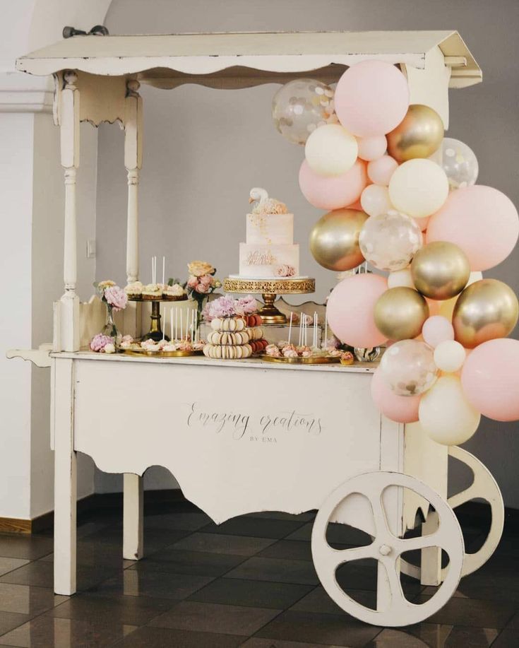 a dessert table with balloons and cake on it