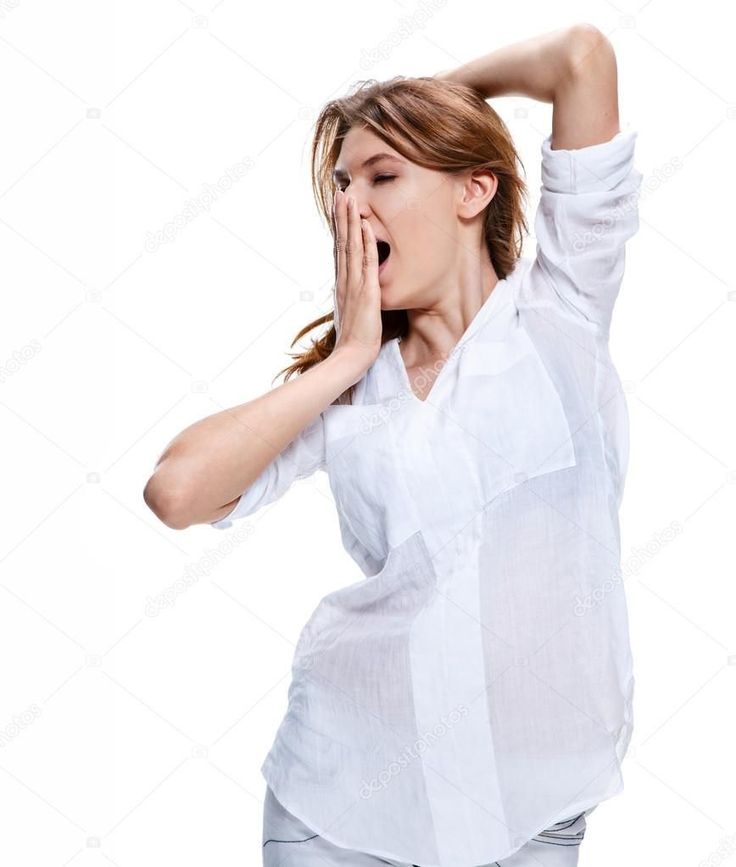 a woman in white shirt holding her hands up to her face while standing against a white background