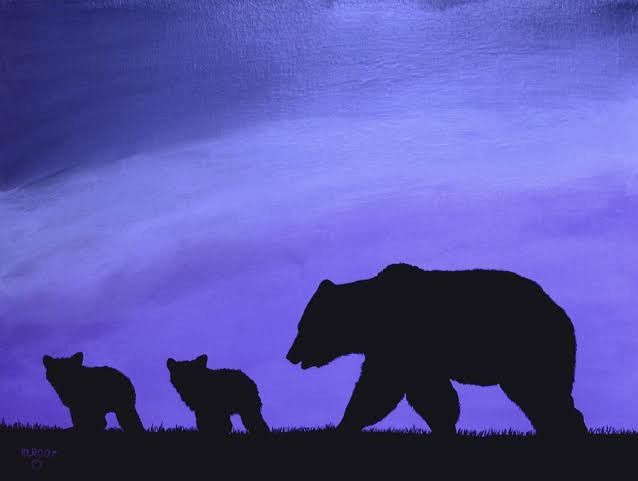 a bear and two cubs are silhouetted against a purple sky