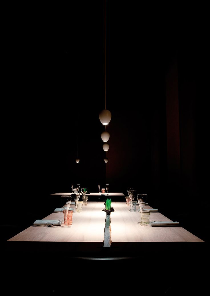 a long table is lit up in the dark