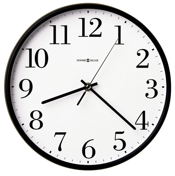 a black and white clock with numbers on the face is seen against a white background