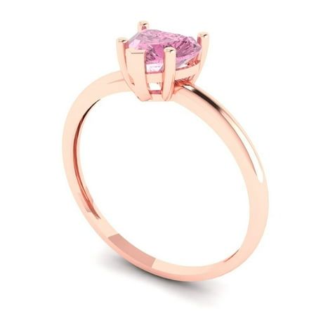 a pink diamond ring on a white background with the center stone set in 18k rose gold