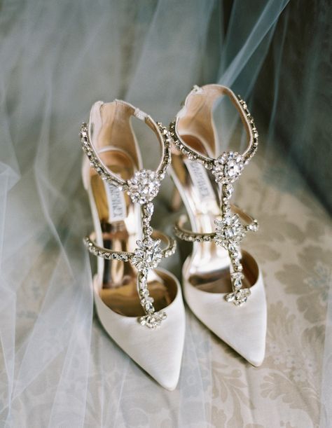 a pair of white high heeled shoes on top of a table