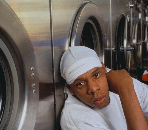 a man leaning against a washing machine