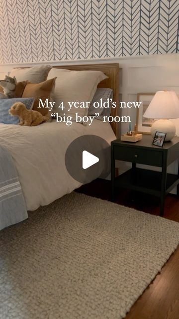 a bed room with a neatly made bed and a teddy bear on the end table