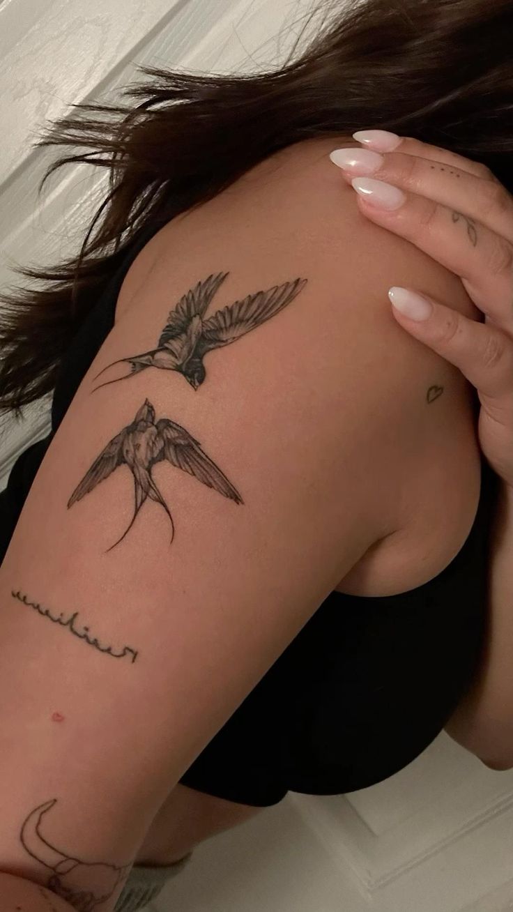 a woman with a bird tattoo on her arm