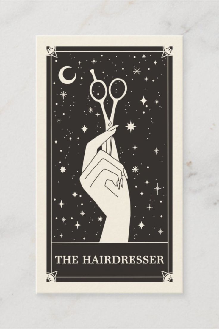 a hand holding scissors with the words the hairdresser on it