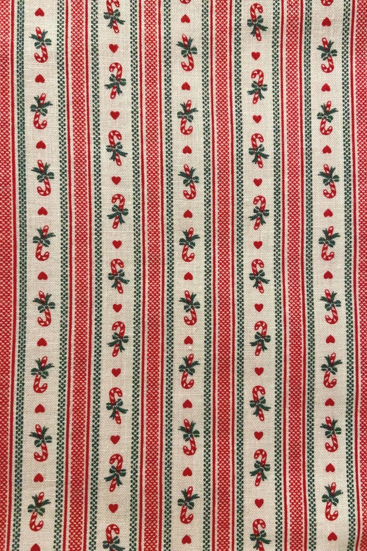 a red and white striped fabric with small flowers on the bottom, and green stripes