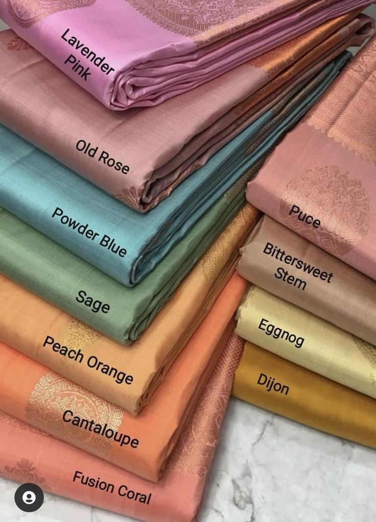 a stack of folded towels with different colors and designs on them, all labeled in the same font