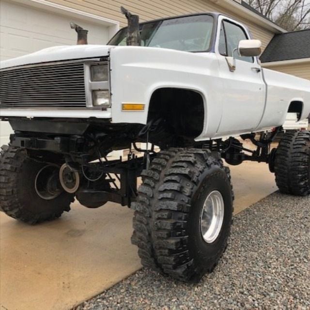 a large white truck parked in front of a house