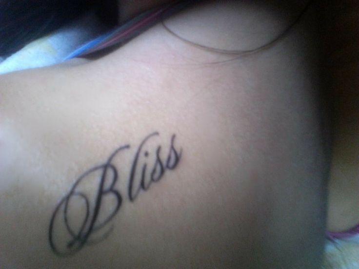 a woman with a tattoo that says bliss