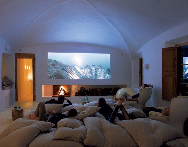 two people laying on bean bags in a living room