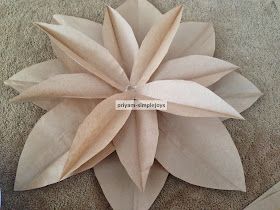 an origami flower made out of paper on the floor