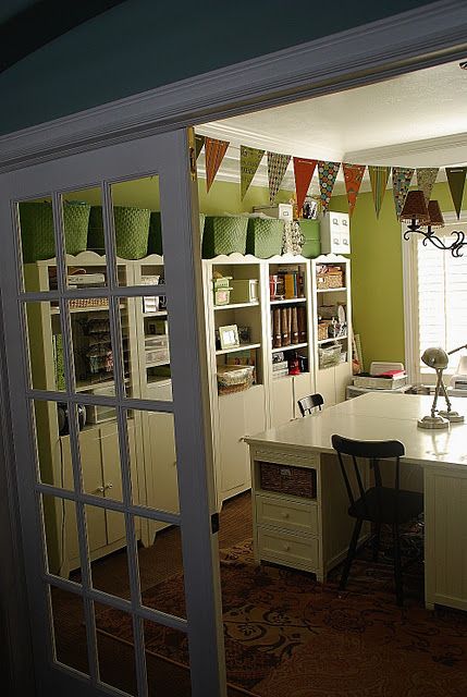 an open door leading into a room with a desk and chairs