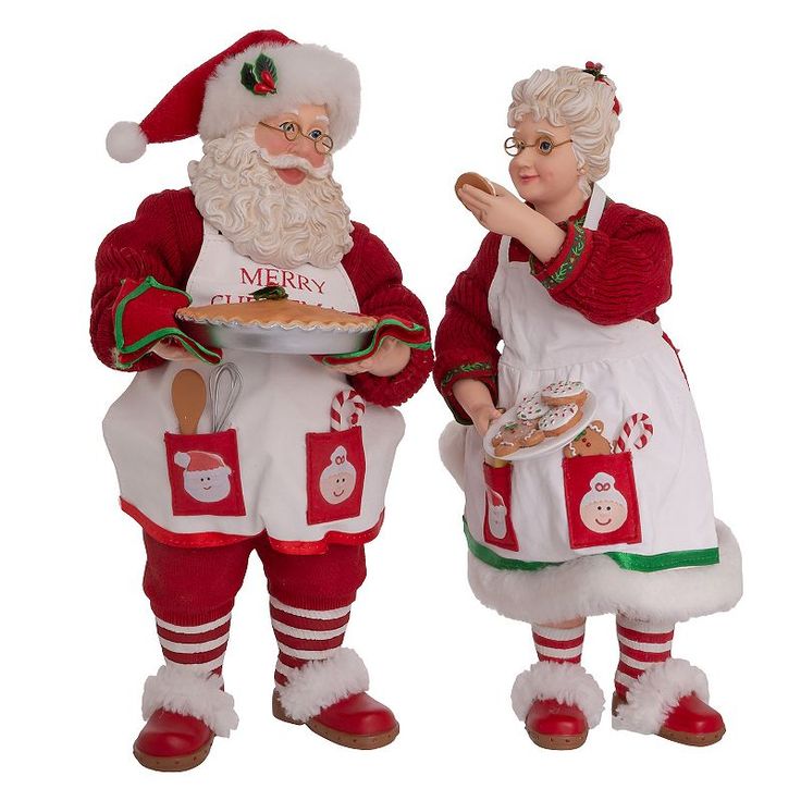 two figurines dressed as santa claus and mrs claus holding a plate of food