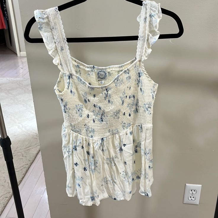 Floral Print Baby Doll Top New With Tags Cute Floral Print Tank Top For Day Out, Blue Ruffled Sleeveless Camisole, Cute Cotton Camisole For Spring, Cute Blue Sleeveless Tank Top, Cute Floral Print Cotton Tank Top, Cute Cotton Tank Top For Vacation, Cream Cotton Tank Top For Summer, Cute Sleeveless Camisole, Cream Tank Top For Summer Daywear