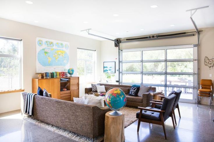 a living room filled with furniture and lots of windows