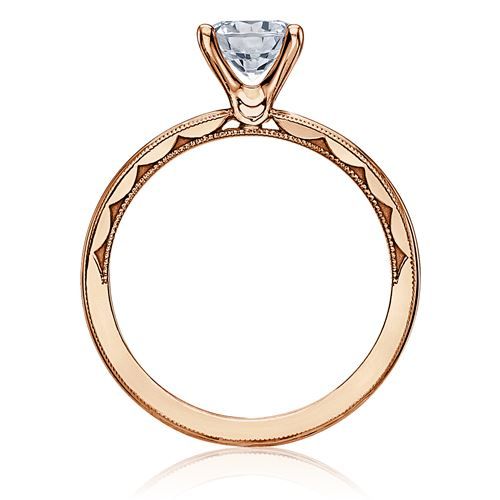 an 18k rose gold engagement ring with a diamond center