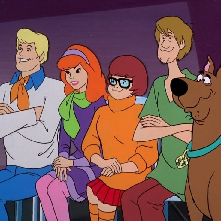 the scooby gang is sitting on a bench with their dog in front of them