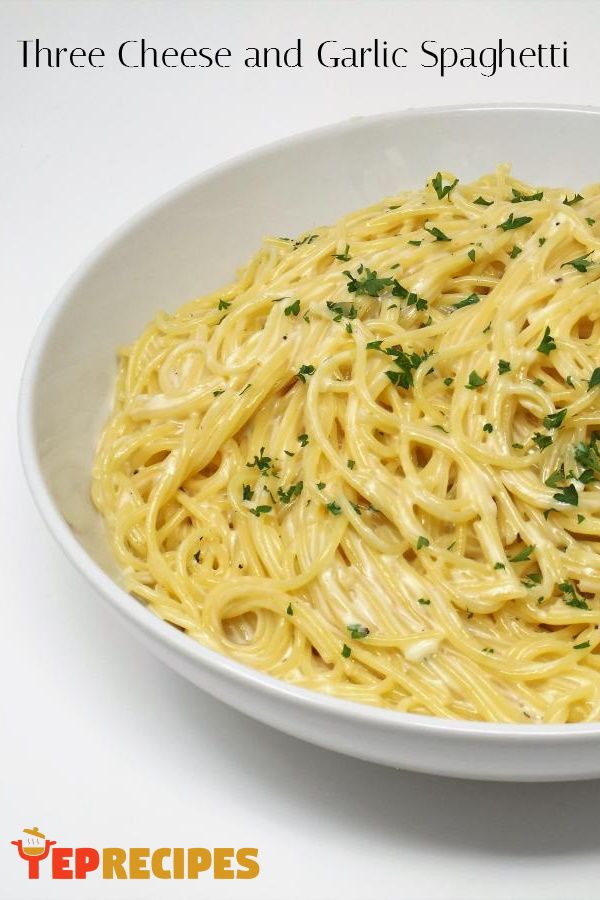 a white bowl filled with pasta and parsley