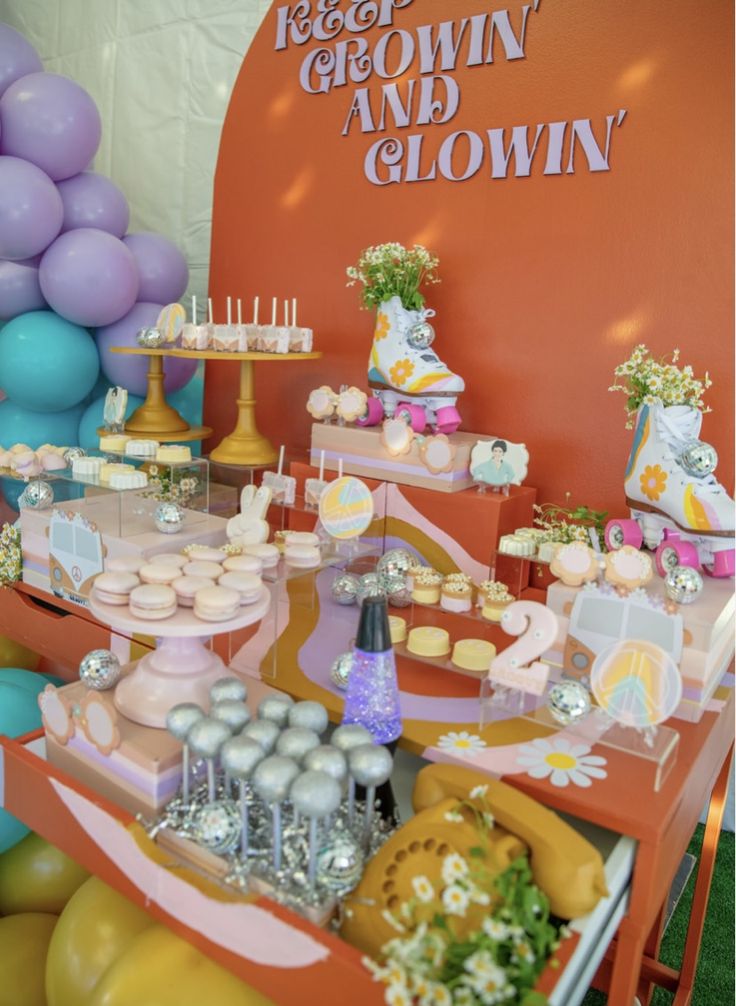 a table filled with lots of cupcakes and desserts on top of it