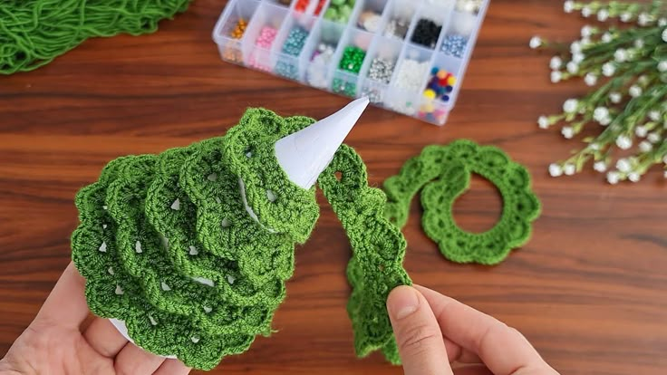 someone is making crochet flowers out of yarn