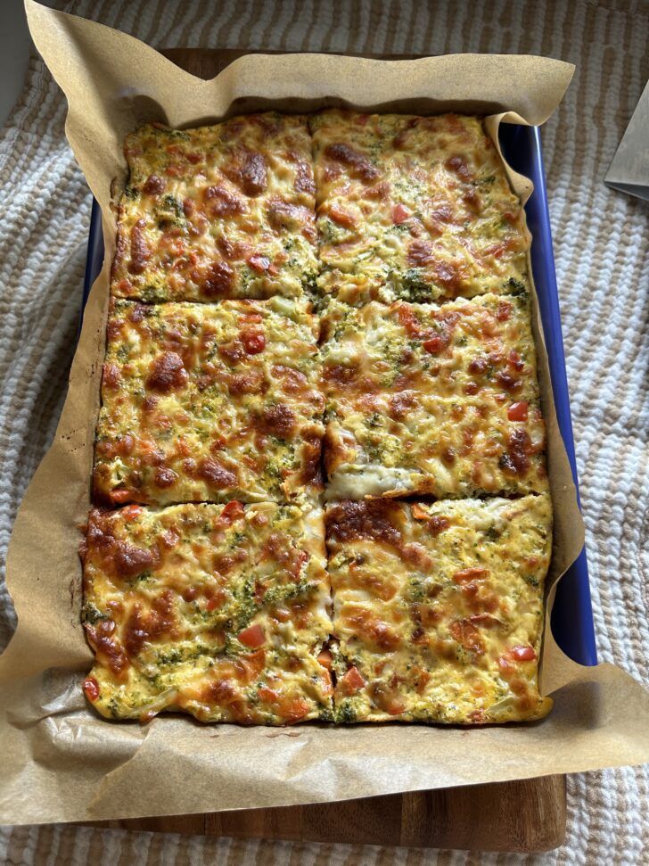 a square casserole in a blue dish on a table