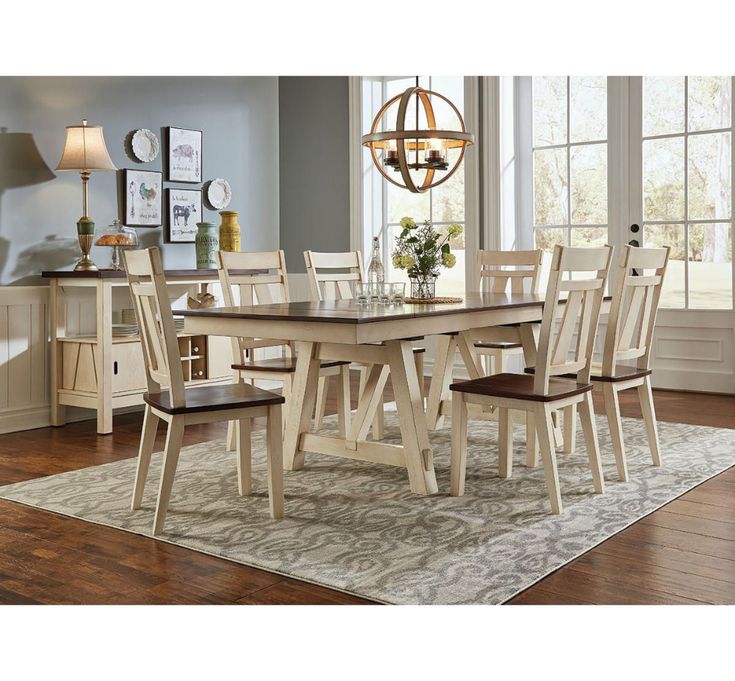 a dining room table with chairs and a chandelier