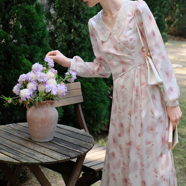 A dress depicting cherry blossom-colored flowers in full bloom in watercolor. Beautiful flowers are embroidered on the collar. The shading and blurred flower pattern gives a romantic impression. Let yourself be invited to a dazzling paradise created by gentle light. 
 
 
 Size 
 
 S size 
 
 Length: 118cm 
 Shoulder width: 34cm 
 Bust: 82-83cm 
 Waist: 68cm 
 Sleeve length: 60cm 
 
 M size 
 
 Length: 120cm 
 Shoulder width: 35cm 
 Bust: 86-87cm 
 Waist: 72cm 
 Sleeve length: 61cm 
 
 L size Feminine Floral Dress For Spring Wedding, Feminine Floral Spring Wedding Dress, Feminine Floral Wedding Dress For Spring, Delicate Floral Print Spring Dress, Spring Wedding Floral Dress V-neck, Spring Wedding Floral Dress With V-neck, Spring Wedding Floral V-neck Dress, Delicate Floral Print Dress For Garden Party, Feminine V-neck Floral Dress For Wedding