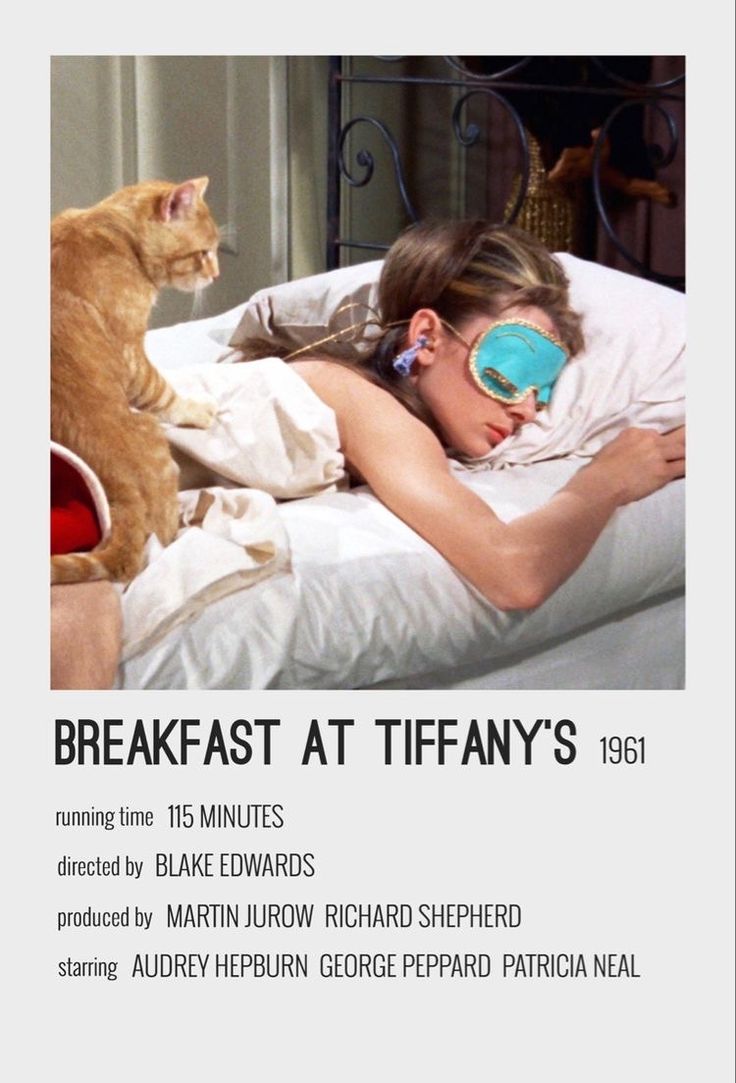 a woman laying in bed with a cat on her back next to her and the caption breakfast at tiffany's