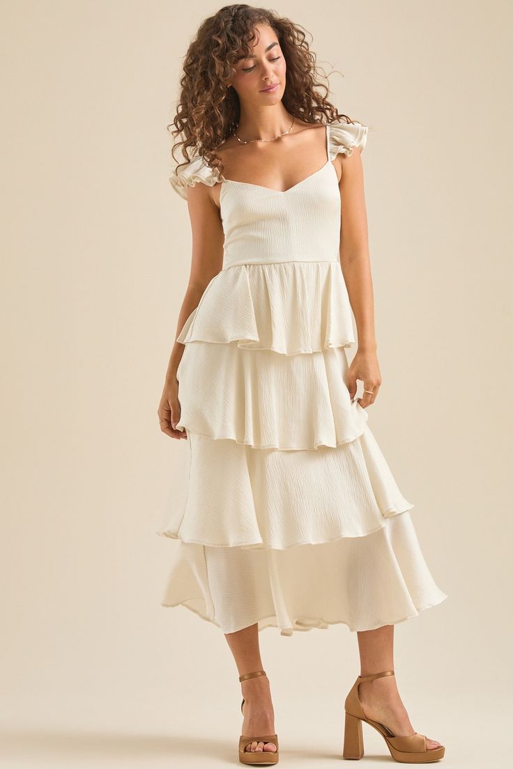 Bronwyn Maxi Dress in Ivory | Altar'd State Flowy Midi-length Ruffle Dress For Brunch, Flowy Ruffle Midi Dress For Brunch, Elegant Maxi Ruffle Dress For Garden Party, Feminine Midi Dress With Ruffle Hem And Tiered Skirt, Flowy Breezy Maxi Dress With Ruffles, Feminine Tiered Skirt Dress With Ruffle Hem, Chic Tiered Midi Dress For Garden Party, Elegant Ruffled Maxi Dress For Brunch, Tiered Midi Dress With Ruffle Hem For Garden Party