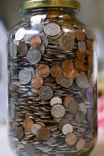 a jar full of coins with a quote on the top that says, finance and prosperity