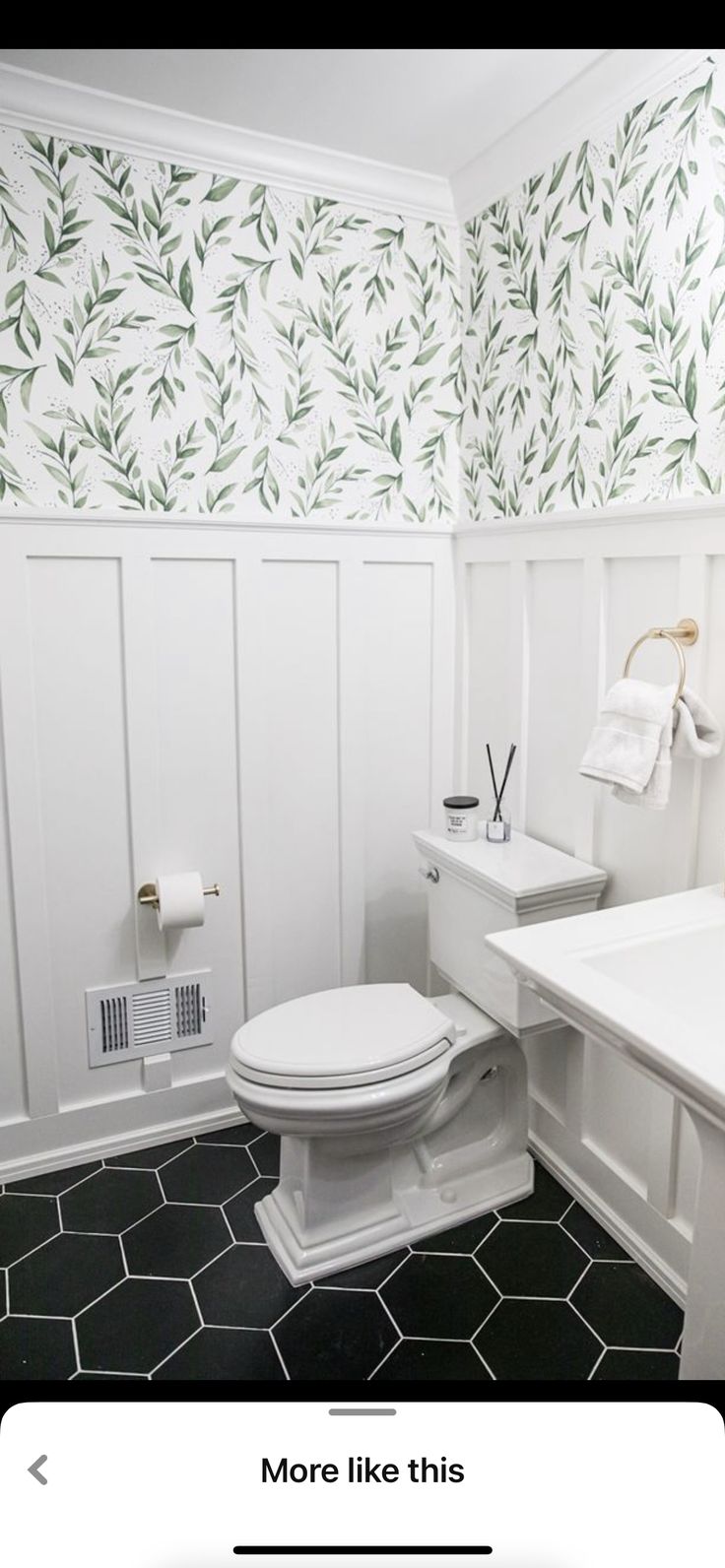 a white toilet sitting inside of a bathroom next to a sink and counter top under a mirror