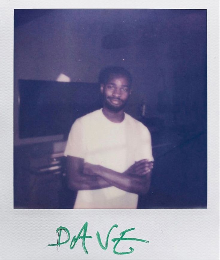 a man standing in front of a piano with his arms crossed and the words dance written on it