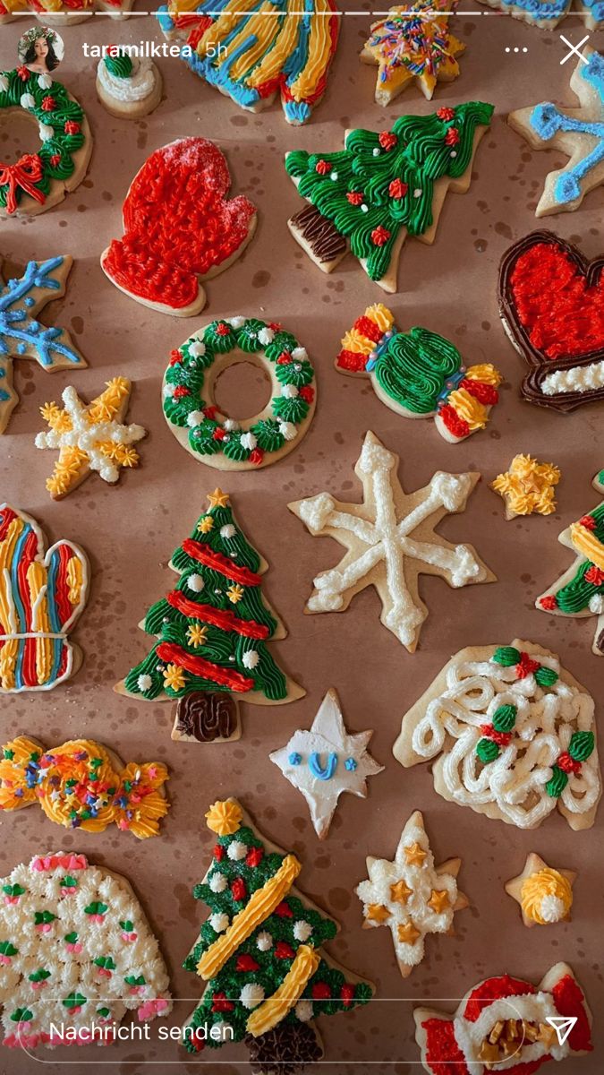 many decorated cookies are displayed on a table