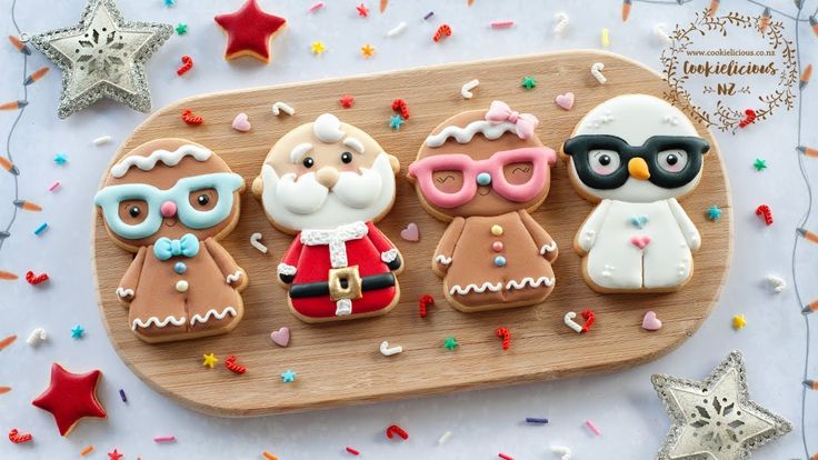 decorated cookies are arranged on a wooden platter