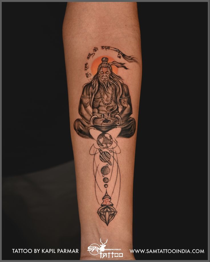 a person with a tattoo on their arm and legs is sitting in the lotus position