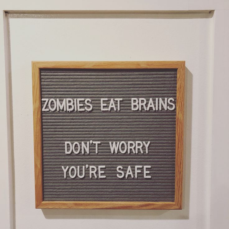 a sign that says zombies eat brains don't worry you're safe on the wall