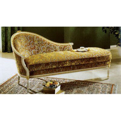 an ornately upholstered chaise lounge chair in gold and brown velvets