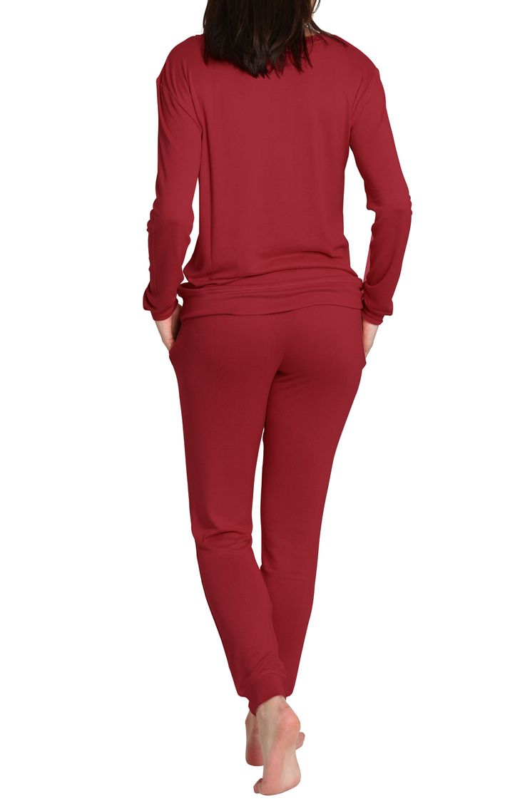 Some long pajamas feature a soft knit design against a crewneck top and matching jogger styled pants. Top has crewneck, long sleeves Pants have elastic waist 97% polyester, 3% spandex Machine wash, tumble dry Imported Model stats: 5'10" height, 32" bust, 25" waist, 36" hip. Model is wearing size S. Comfortable Long Sleeve Casual Sleepwear, Casual Long Sleeve Comfortable Sleepwear, Red Relaxed Fit Sleepwear For Loungewear, Red Relaxed Fit Sleepwear, Long Sleeve Sleepwear With Elastic Waistband For Relaxation, Fall Crew Neck Activewear For Lounging, Fall Activewear Crew Neck For Lounging, Athleisure Top With Elastic Cuffs For Loungewear, Casual Fall Sleepwear For Loungewear