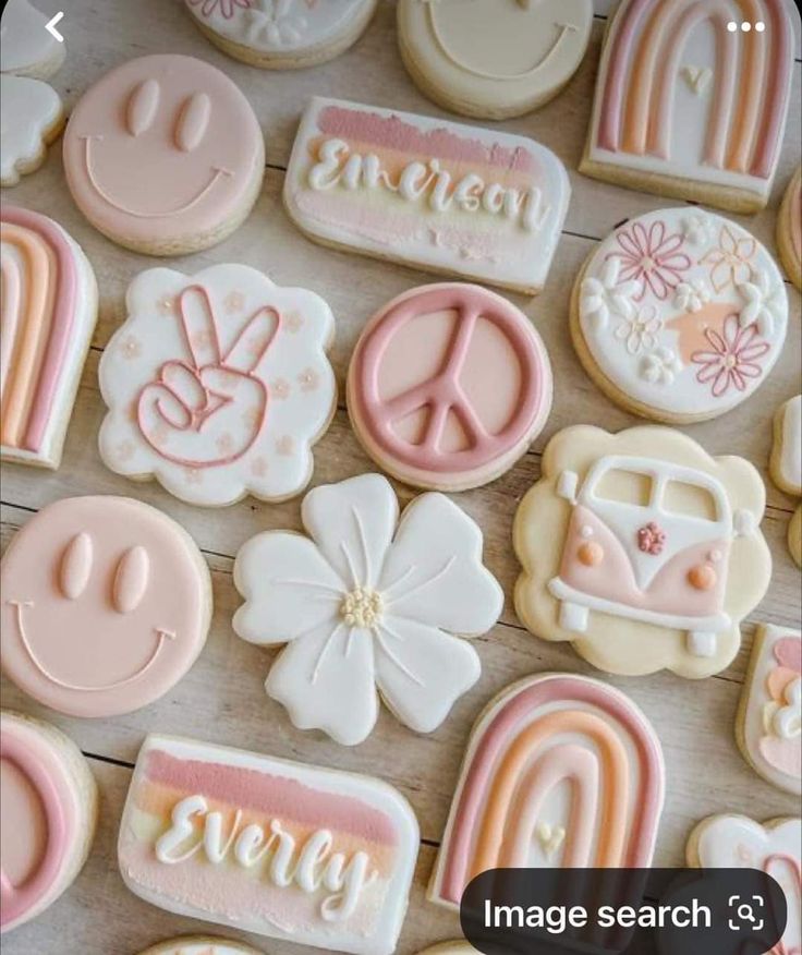 some cookies that are decorated with different designs and words on them, all in pastel colors