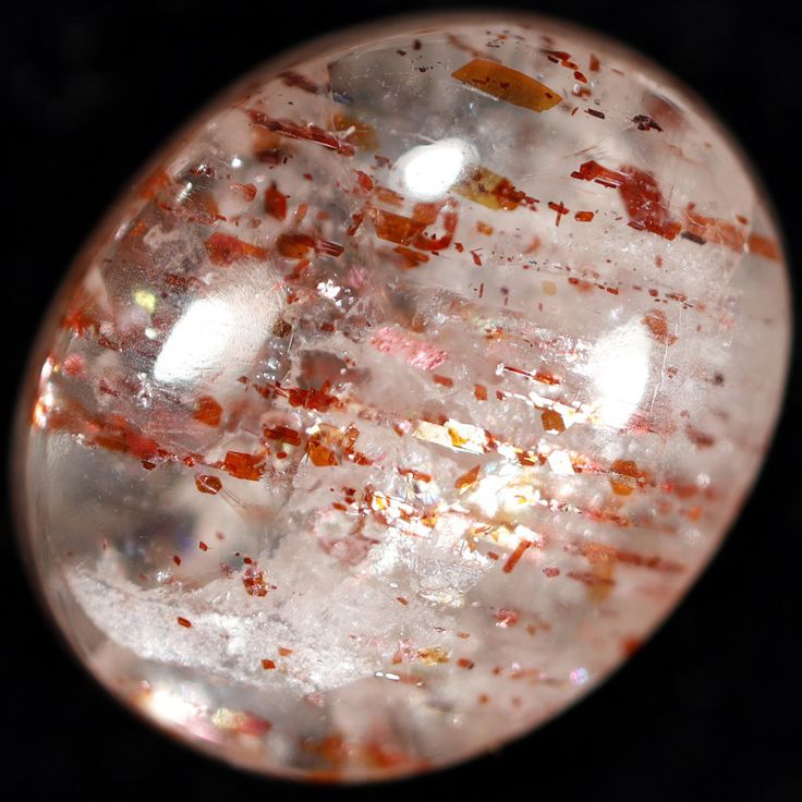 a glass object with red and white speckles on it