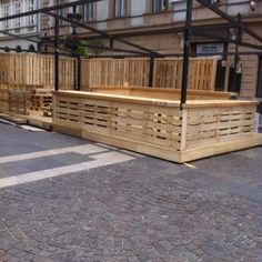 several wooden pallets are lined up on the street