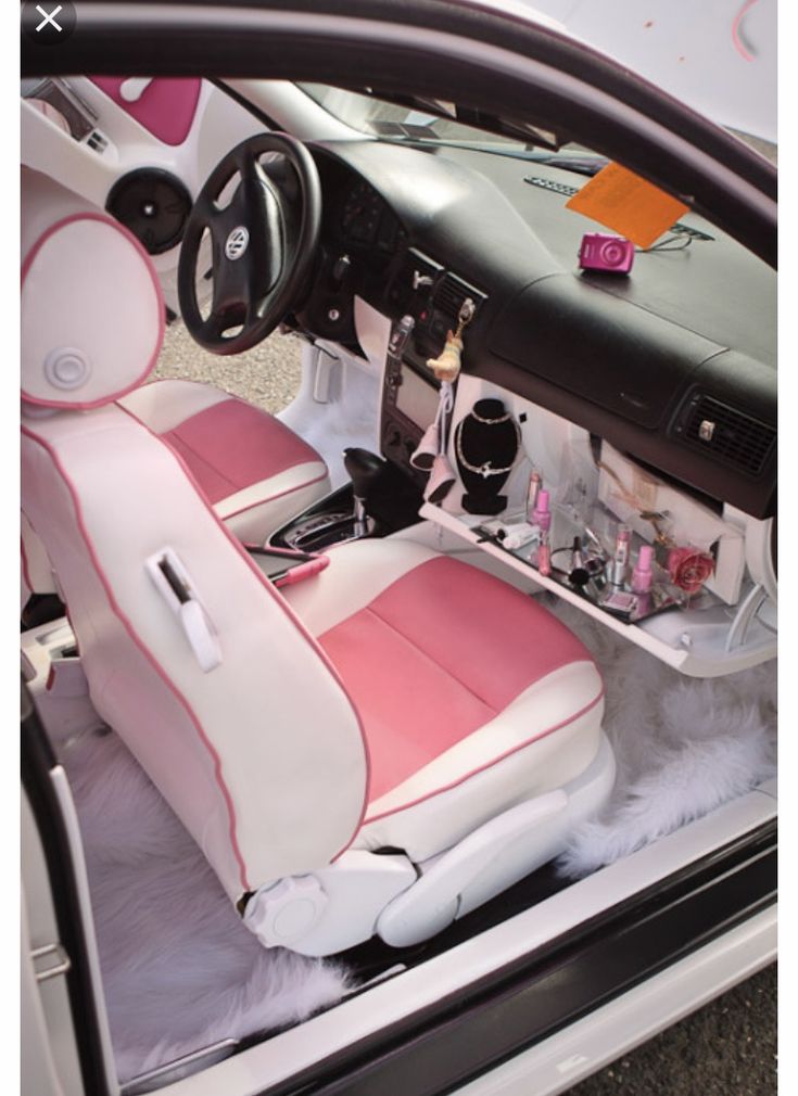 the interior of a car with pink and white leather