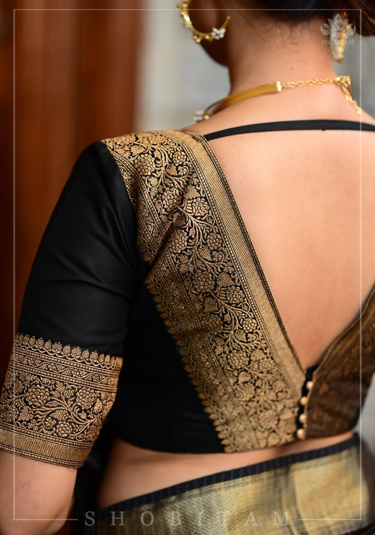 Step into any gathering with style! The timeless combination of bold black and luxurious gold is beautifully tailored to create a bold and beautiful silhouette. The wide zari borders add statement to the neckline in the front and back and being black, it can be effortlessly paired with many sarees! Need minor customizations? Ask us and we will try our best to make it happen! SIZE GUIDE : To determine your blouse size, please measure around the fullest part of your bust line using a measuring tape. Your bust measurement will correspond to the size you need to order. For example, if you measure 36 inches, please order size 36. If your measurement falls between sizes, you may order the next size up (for example, if you measure 39 inches, please order size 40) or consult with us for tailored o Deep V Neck Blouse, Lace Blouse Design, Model Blouse Designs, Blouse Designs Catalogue, Best Blouse Designs, Fashionable Saree, Latest Blouse Designs Pattern, Saree Blouse Neck Designs, Traditional Blouse Designs