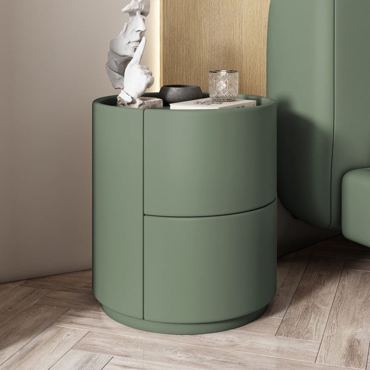 a green round side table next to a couch