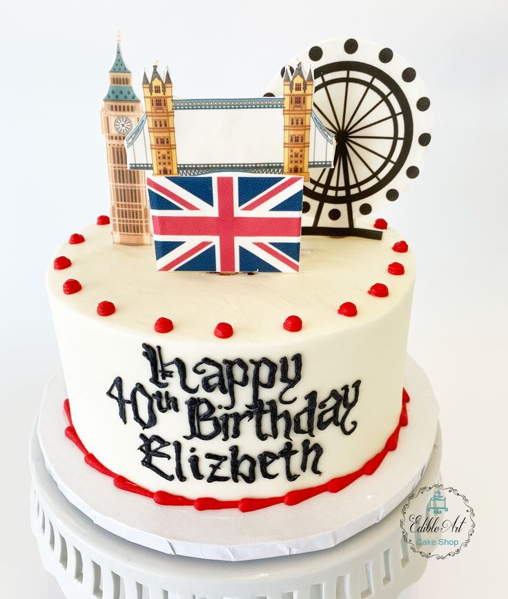 a birthday cake decorated with the british flag and big ben in london, england on a white background