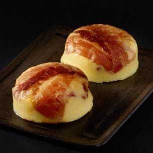 two pieces of bread sitting on top of a black plate