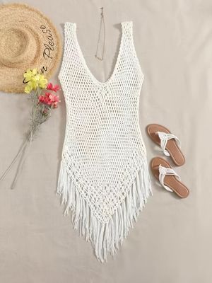 white crochet swimsuit with flowers, straw hat and sandals laying on bed